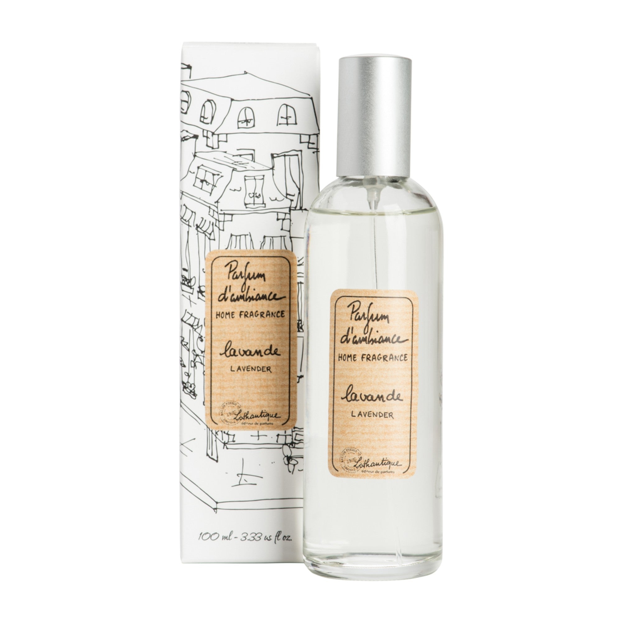 A clear glass room spray bottle with a label next to its packaging featuring a drawing of a house.