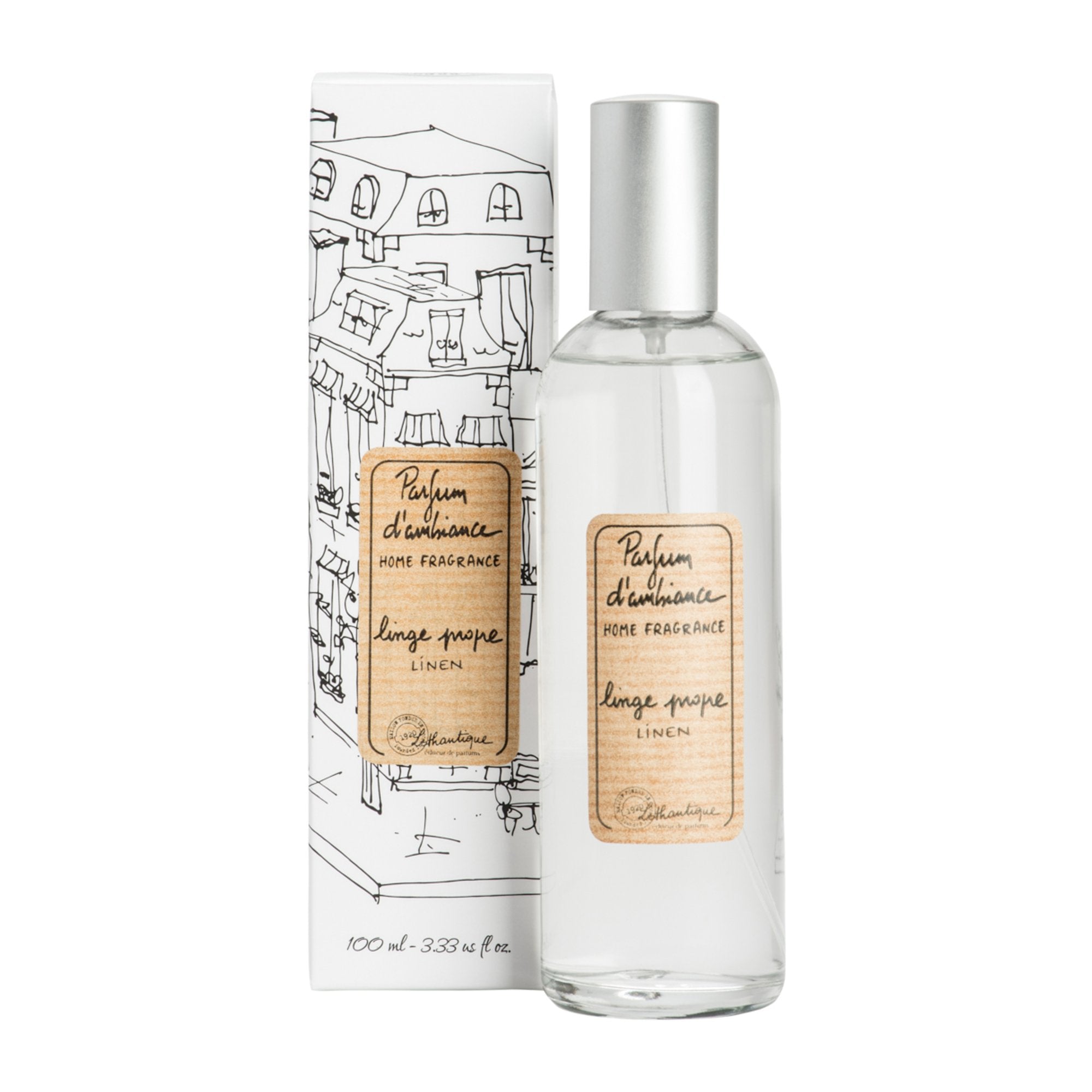 A clear glass room spray bottle with a label next to its packaging featuring a drawing of a house.