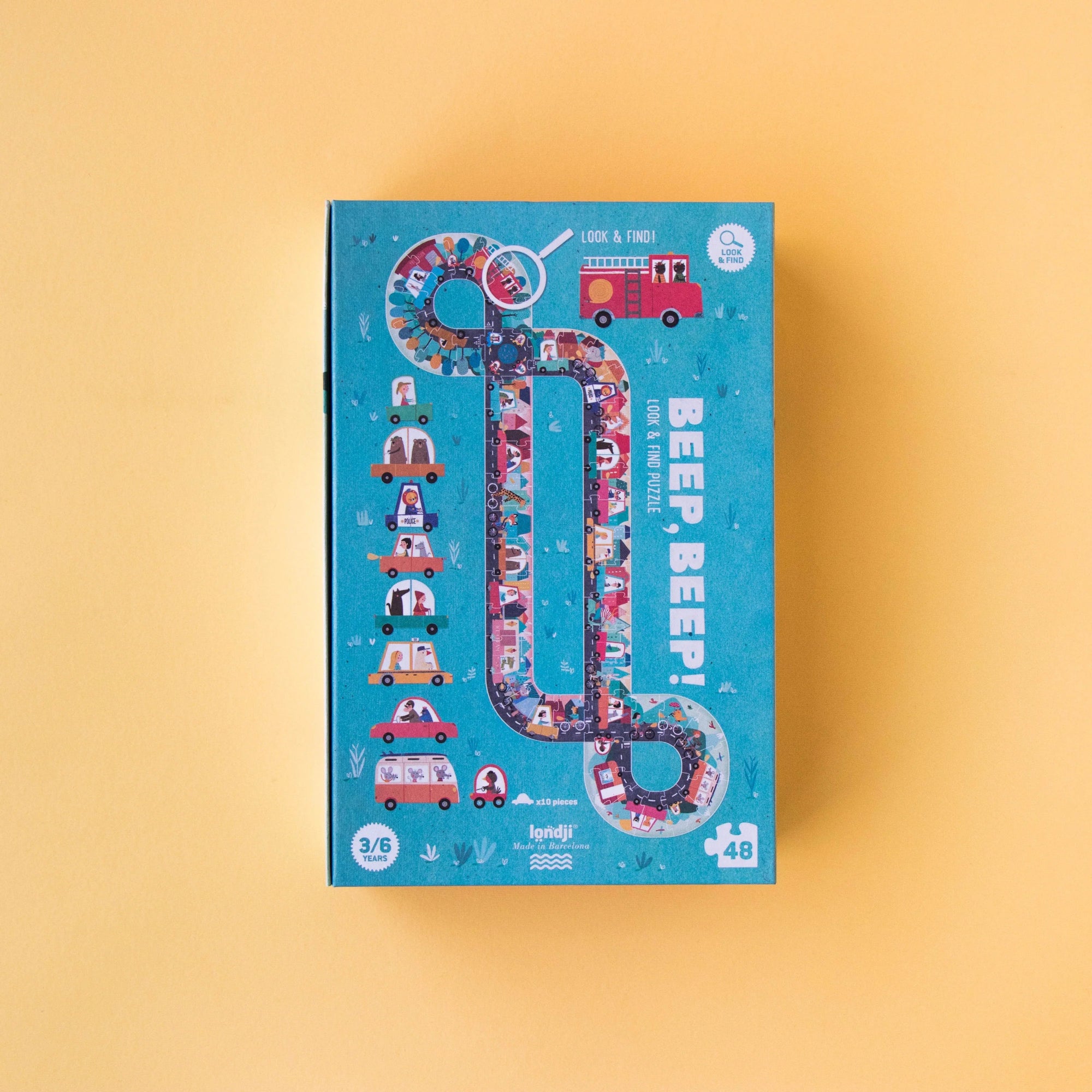 Children's puzzle box with colorful design on a yellow background