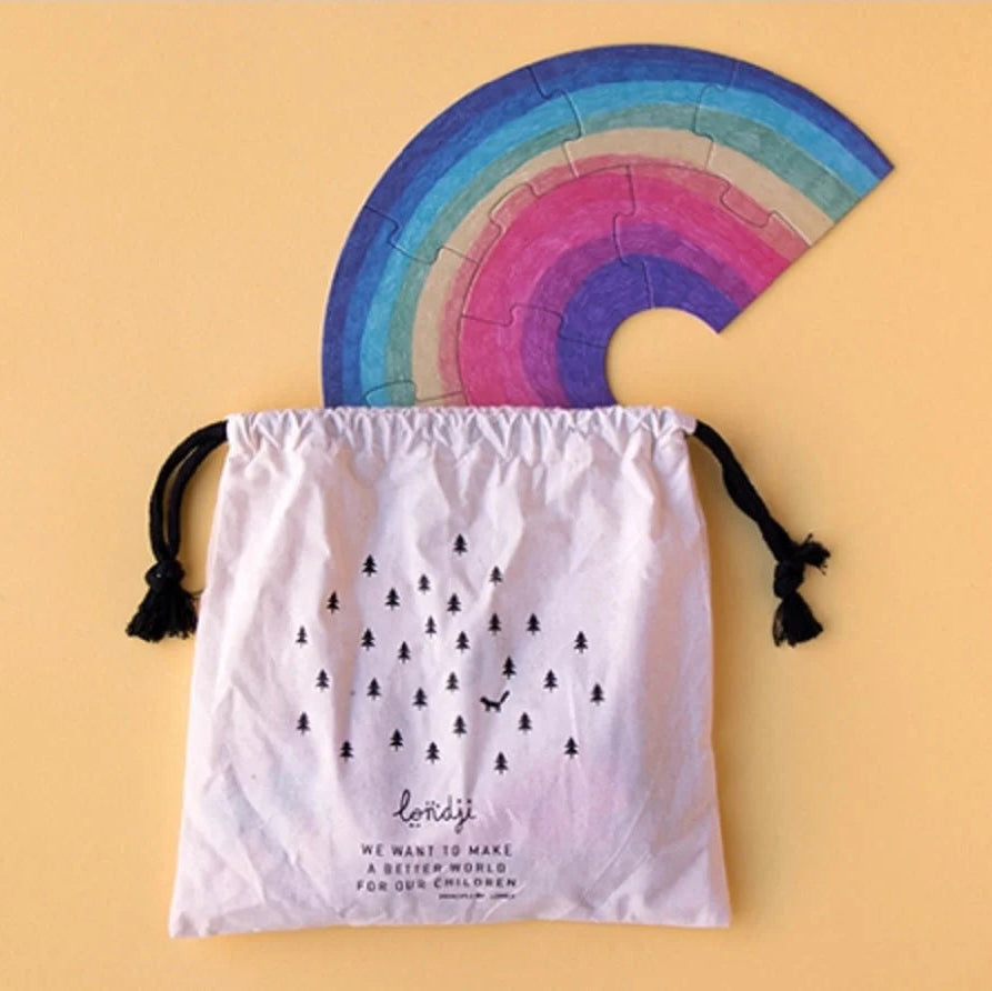 Colorful half-circle puzzle with a drawstring bag on a beige background