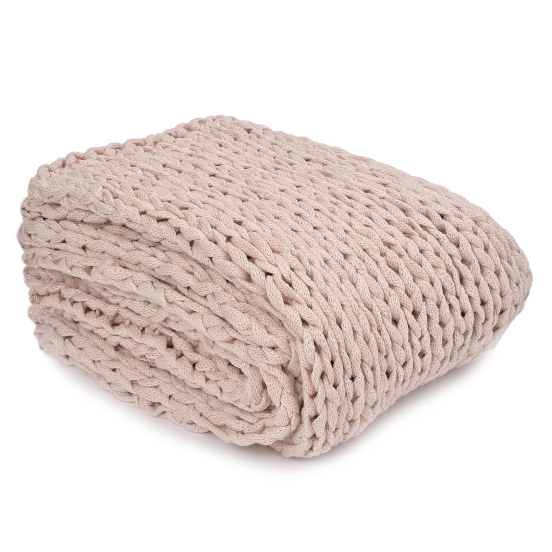 A folded rosewater pink cotton throw blanket with a textured knit pattern.