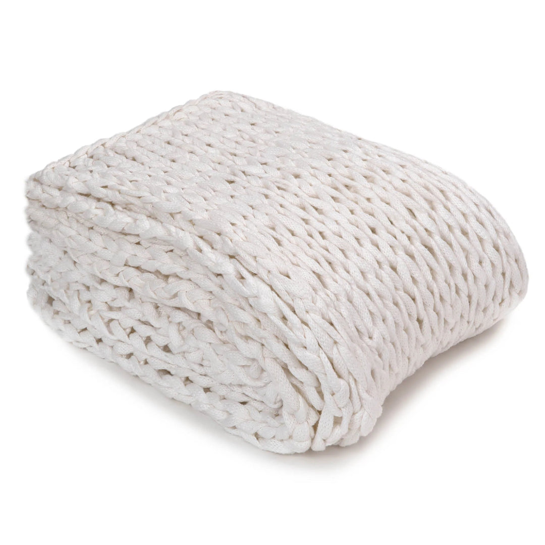 A folded white cotton throw blanket with a textured knit pattern.