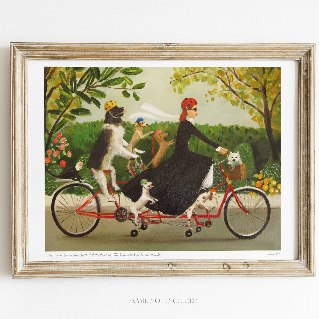 Framed artwork of a woman riding a tandem bicycle with dogs in a garden setting.