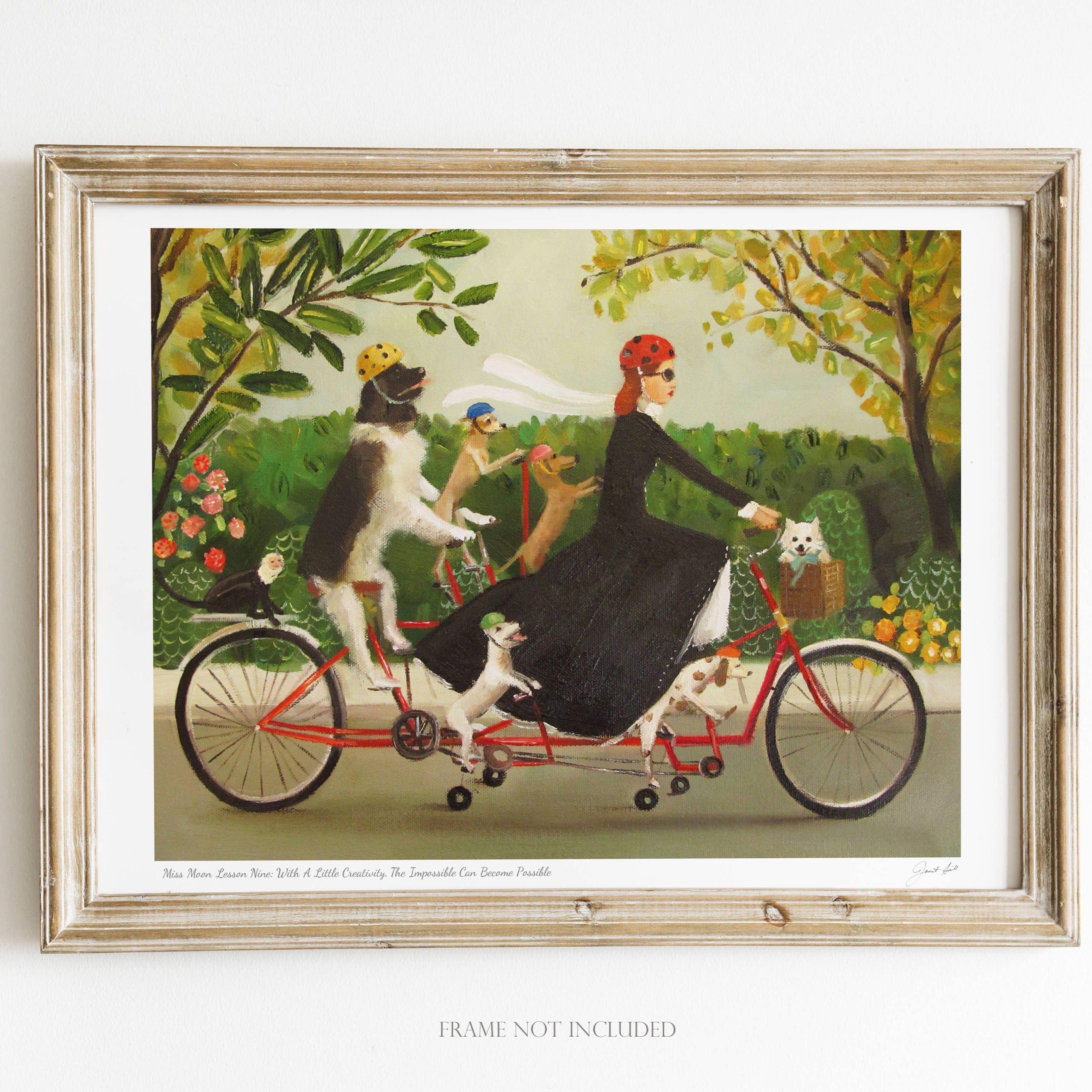 Framed artwork of a woman riding a tandem bicycle with dogs in a garden setting.