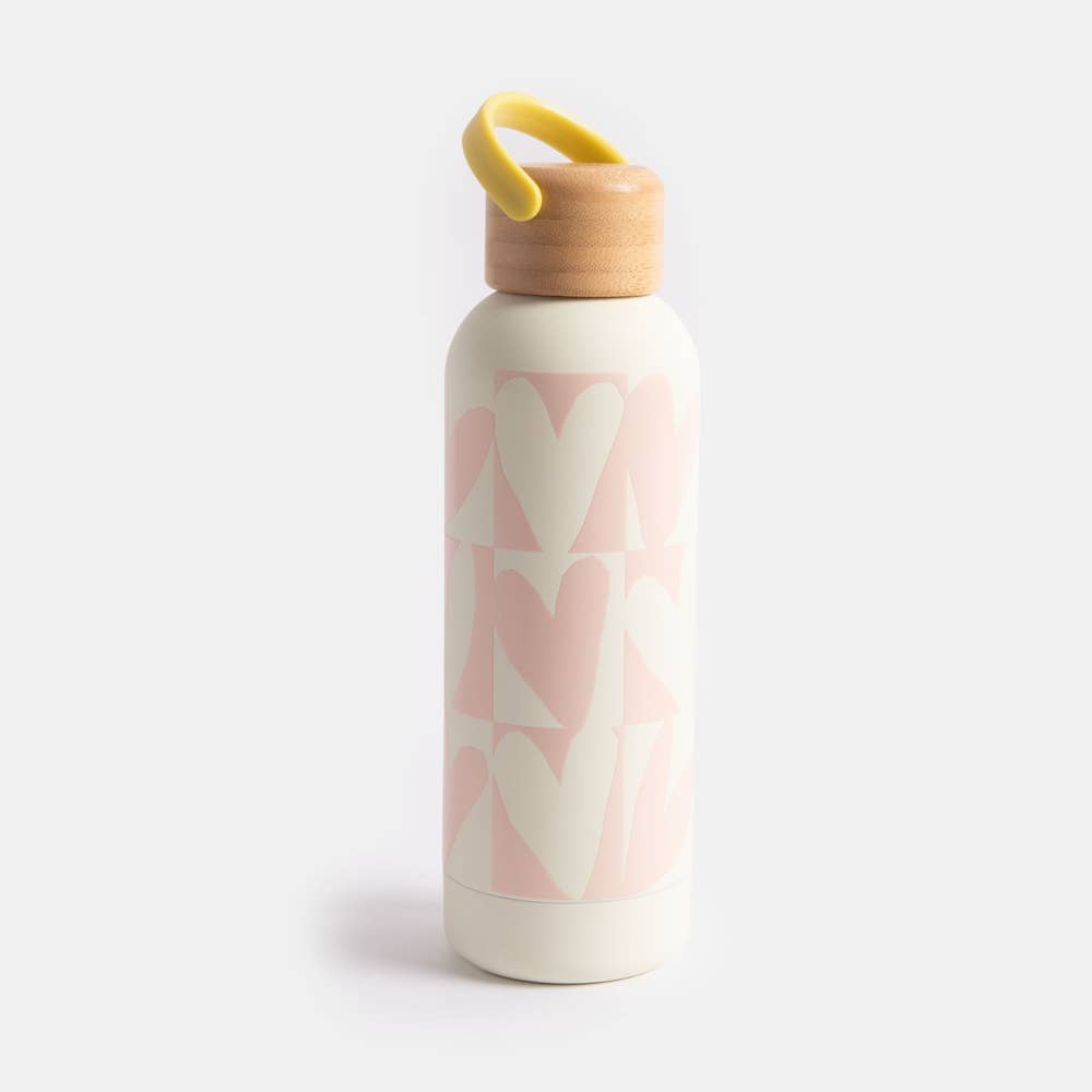 Water bottle with pink heart pattern and wooden cap on a white background