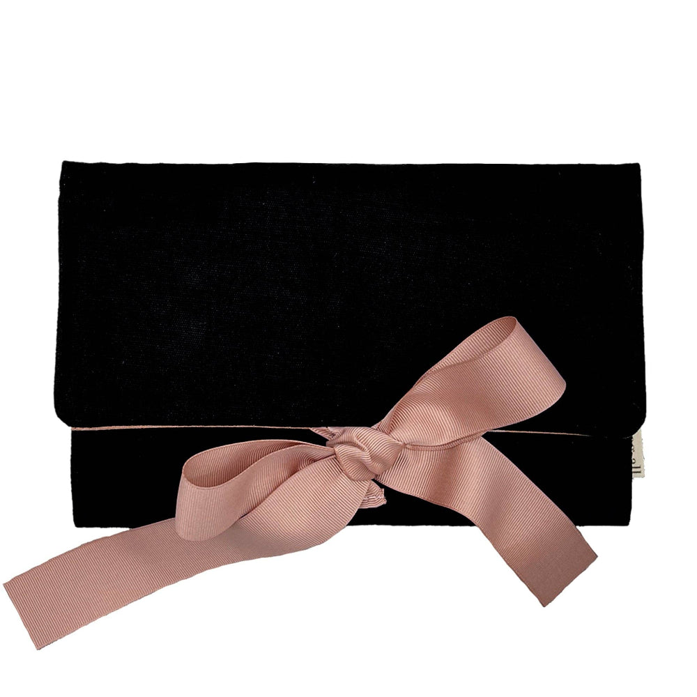 Black clutch bag with a pink ribbon on a white background