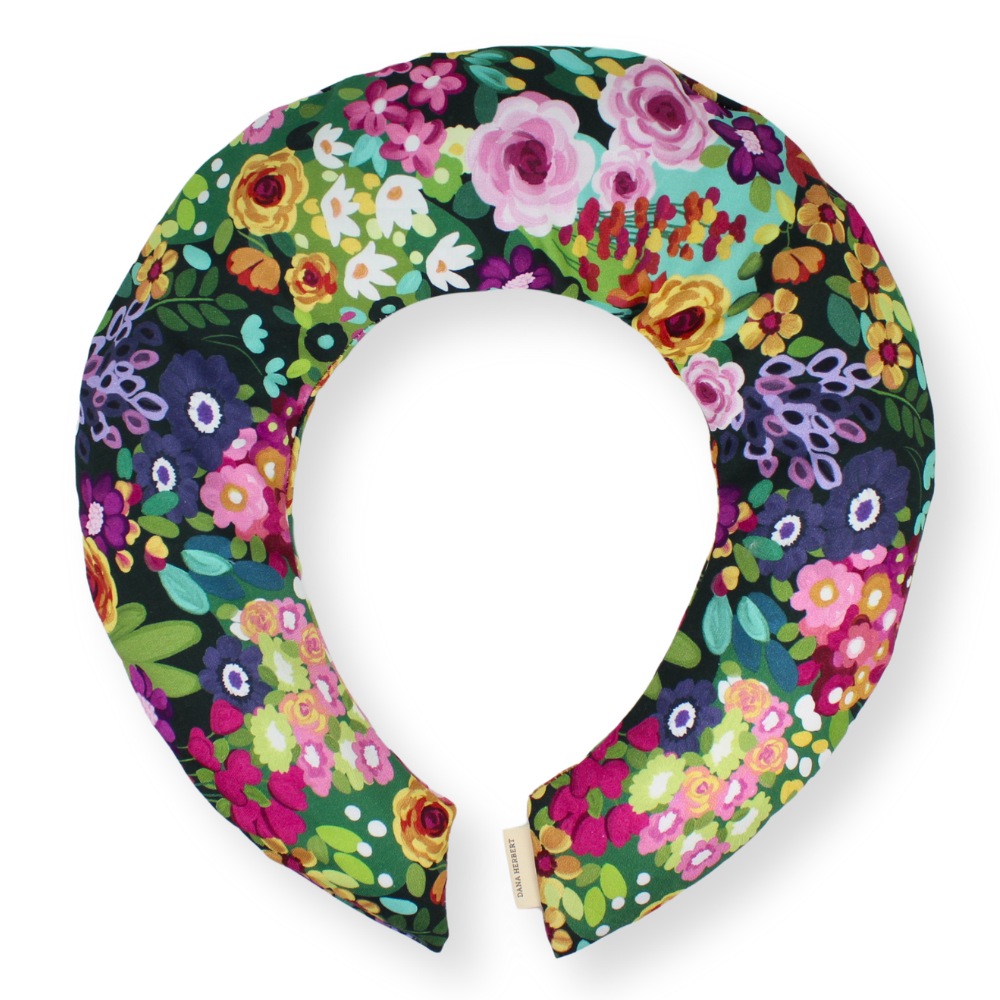 Floral patterned neck pillow on a white background
