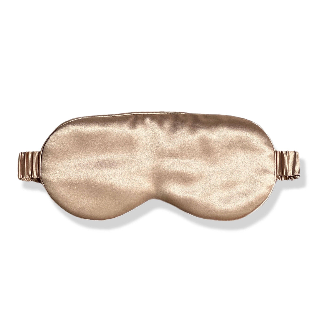 A premium organic silk sleep mask in champagne color with a luxurious design.