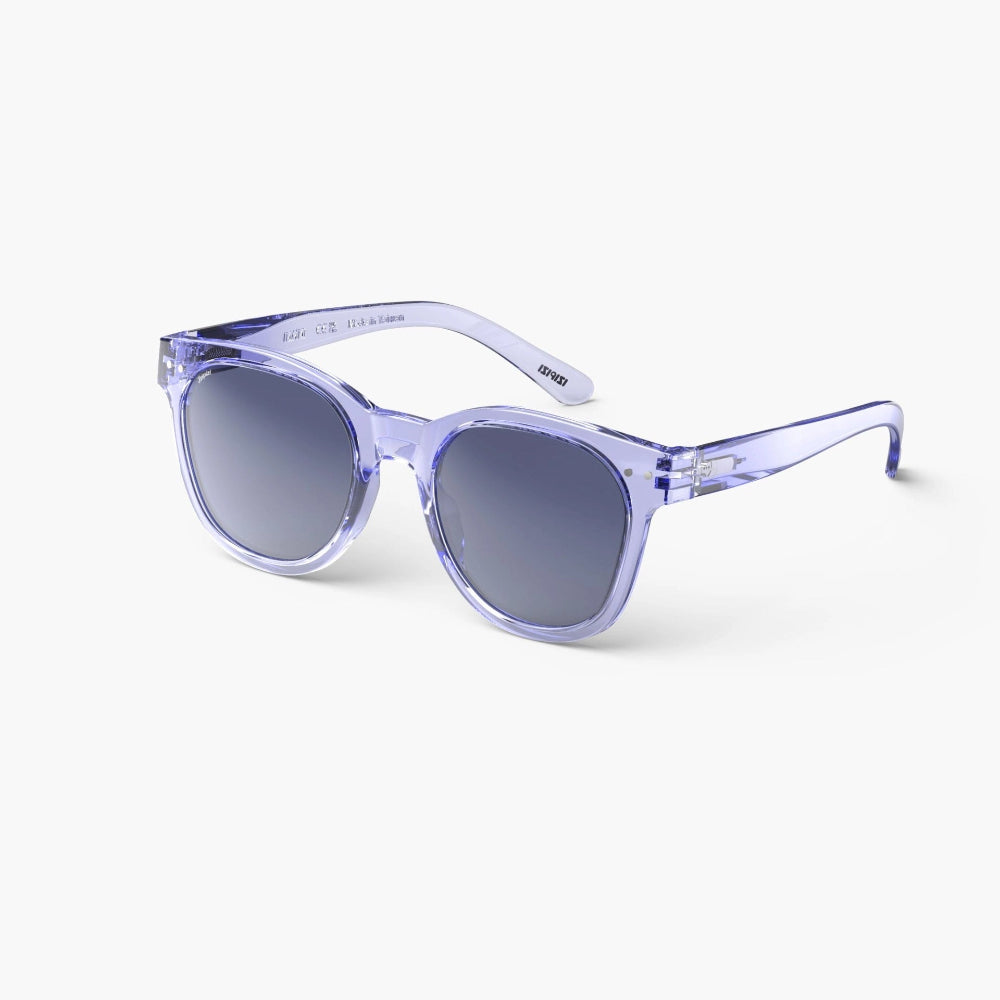 A pair of round-framed purple sunglasses with a transparent plastic design, showcasing flexible arms and a rubber texture.