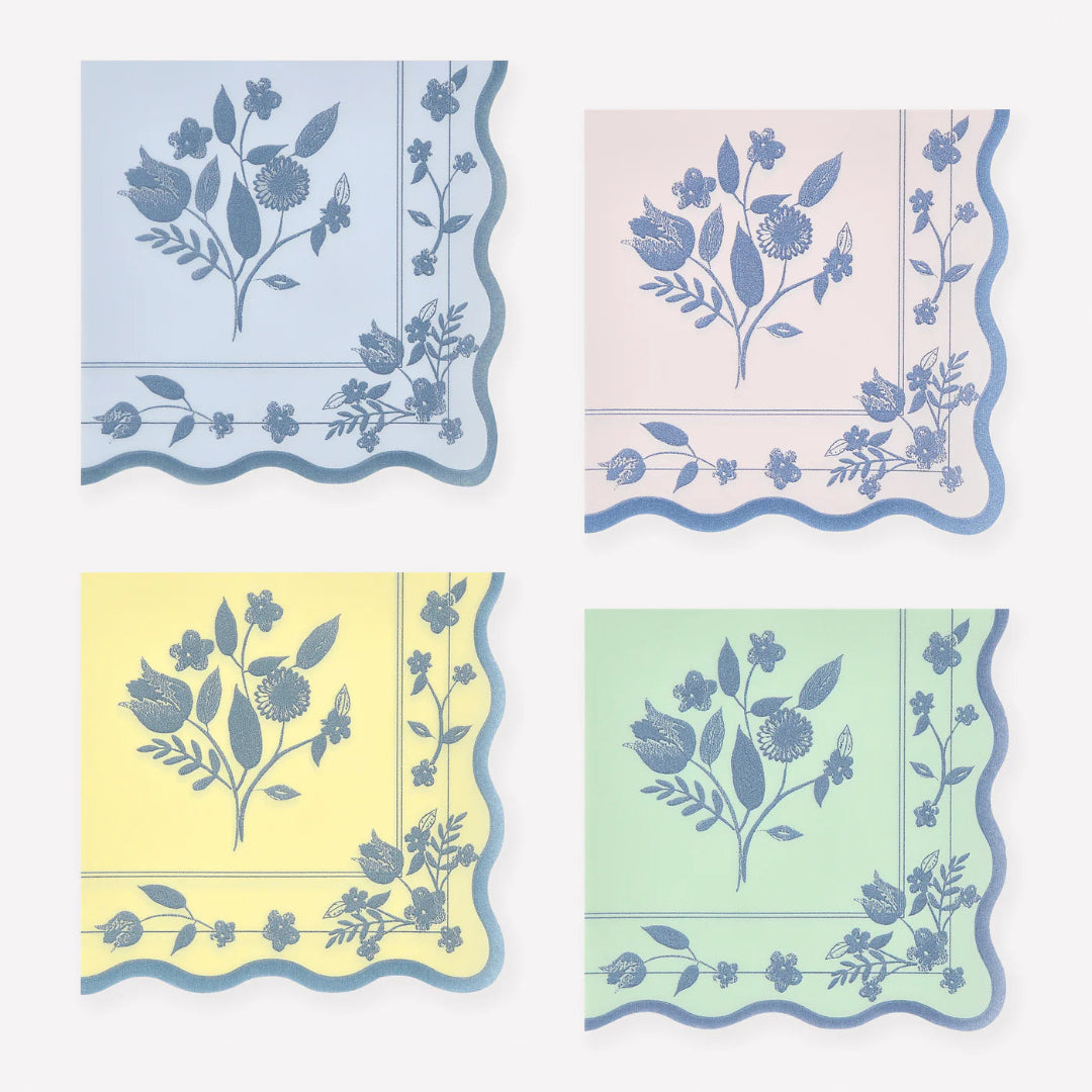 Set of four floral-patterned napkins in pastel colors on a white background