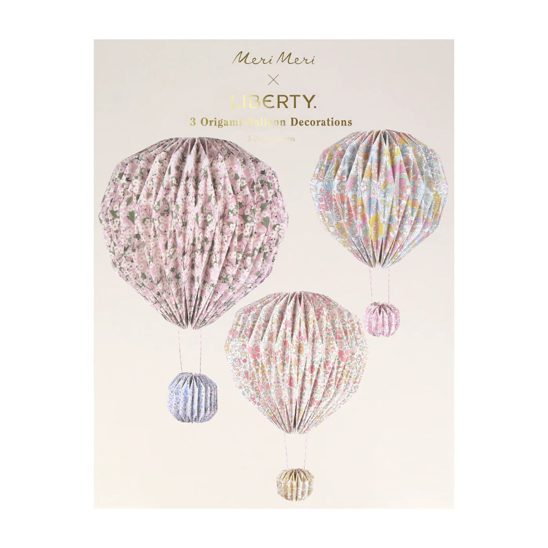 Packaging of floral hot air balloon decorations by Meri Meri x Liberty on a beige background.
