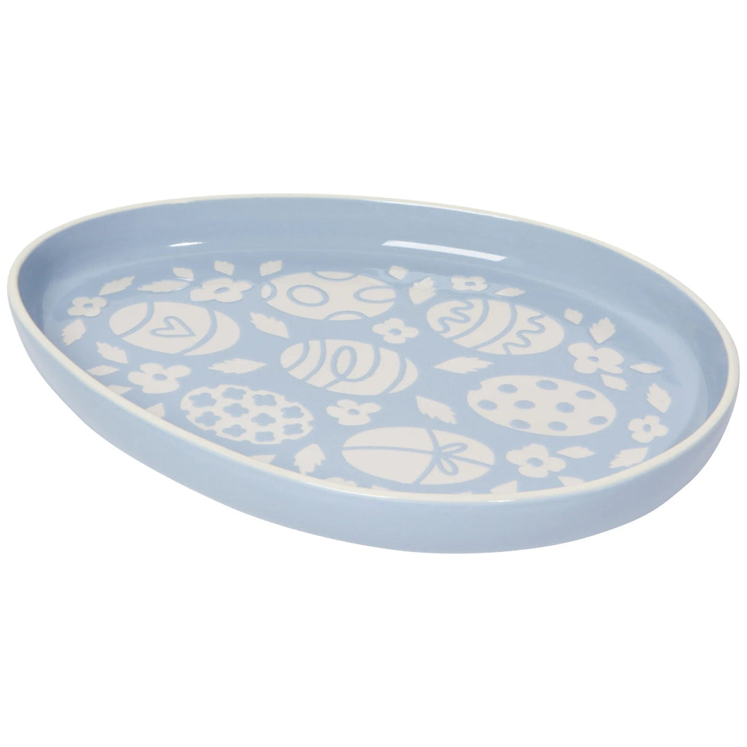 Blue ceramic plate with white floral patterns on a white background