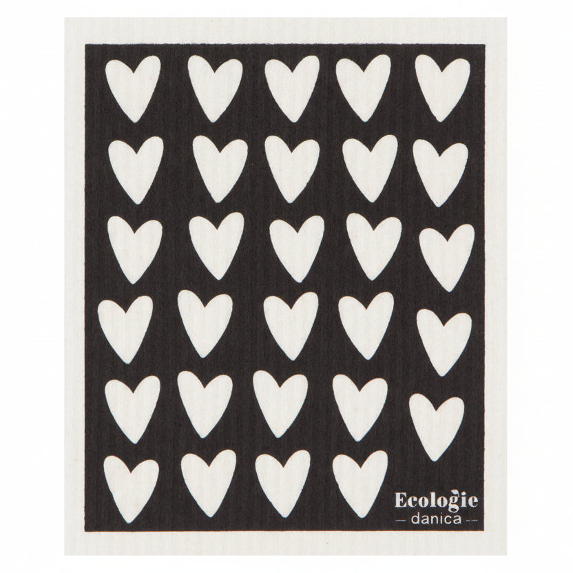 A black and white dishcloth with white hearts pattern, and the brand 'Ecologie' visible.