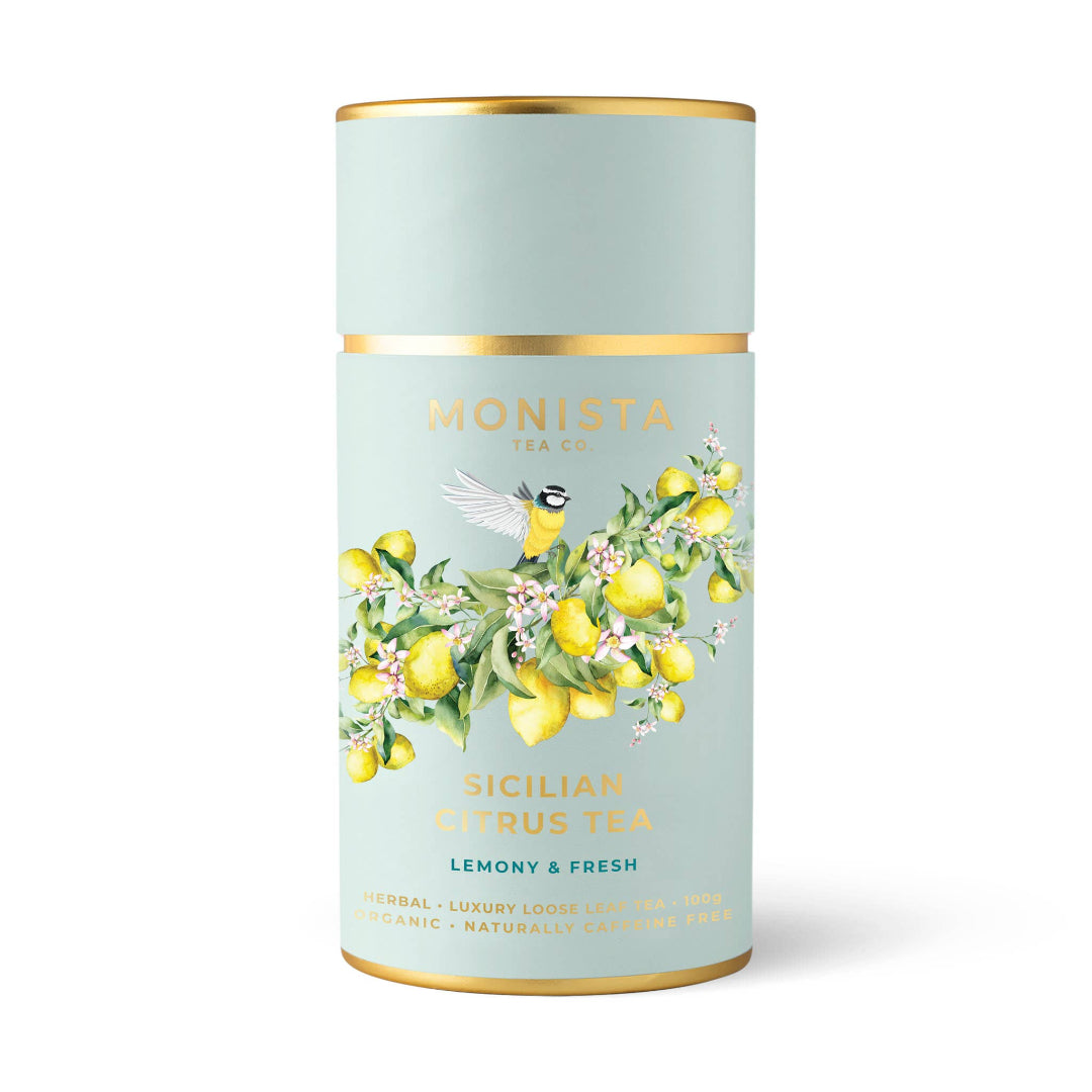 Tea canister with lemon design and 'Monista Tea Co' branding on a light blue background