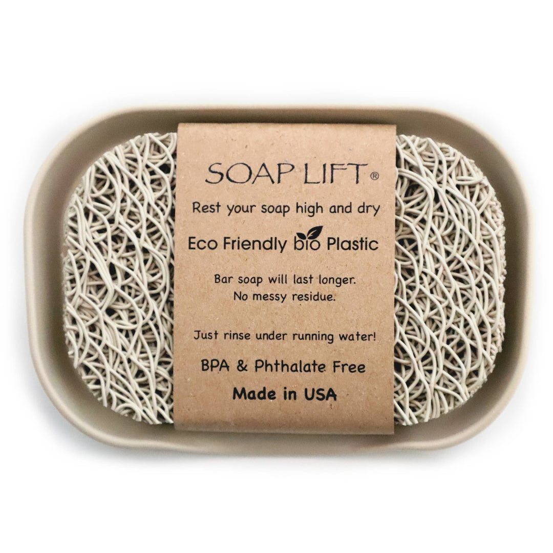A beige soap dish with a 'SOAP LIFT' label, designed to hold a soap saver lift, with product information and branding visible.