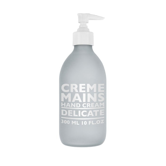 A pump bottle of hand cream labeled 'CREME MAINS DELICATE' containing 300ml of the product.