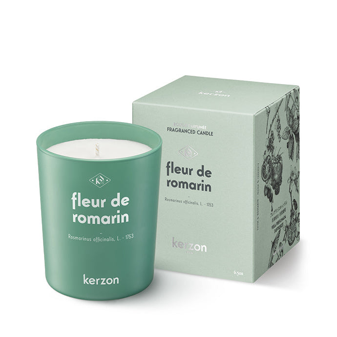A Kerzon Fleur de Romarin fragranced candle in a green container, alongside its packaging box with floral patterns.
