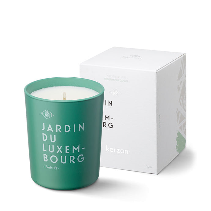 A green candle with white and green label reading 'JARDIN DU LUXEMBOURG' along with the Kerzon brand logo, presented in a white box with a clear window displaying the candle inside.