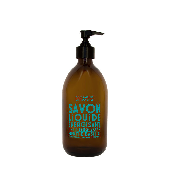 A brown glass bottle with a black pump containing liquid soap, labeled in green and white text.