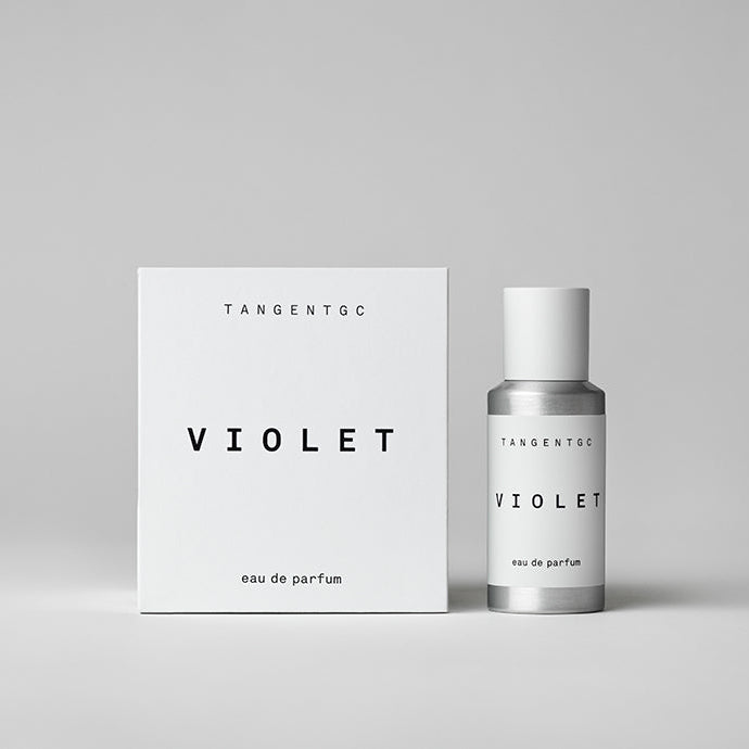 A white bottle and box labeled 'Tangent GC Violet Eau de Parfum